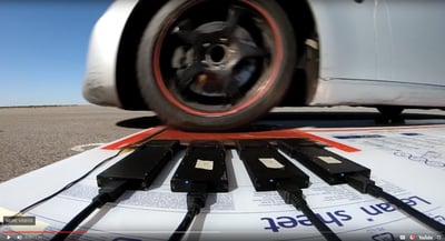 XSENSOR's High-Speed Tire System next to a vehicle.