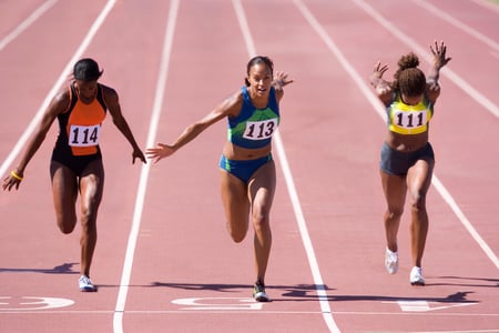 athletes sprinting on track